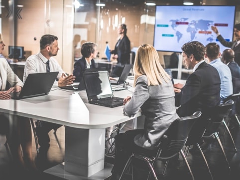Group of people having a meeting in a conference room watching presentation